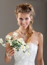 Beautiful smiling bride in the veil with bouquet. Gray Background Royalty Free Stock Photo