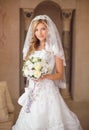 Beautiful smiling bride woman with bouquet of flowers, wedding m