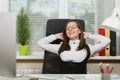 Beautiful business woman in suit and glasses working at computer with documents in light office Royalty Free Stock Photo