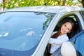 Beautiful smiling brunette girl behind the wheel of a car Royalty Free Stock Photo