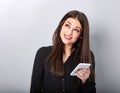 Beautiful smiling brunette woman in black style shirt holding in hand, use mobile cell phone and thinking looking up isolated on Royalty Free Stock Photo