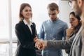 Beautiful smiling businesswoman and businessman handshaking standing in office, nice to meet you, first impression, being promoted Royalty Free Stock Photo