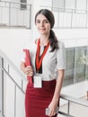 Beautiful Smiling Businesswoman Standing Against White Offices Background. Portrait of Business Woman With a Folder in Her Hands Royalty Free Stock Photo