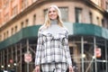 Beautiful smiling businesswoman walking on city street wearing stylish outfit suit. Royalty Free Stock Photo