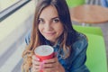 Beautiful smiling cheerful excited happy nice glad cute lovely woman with big eyes and charming smile holding a cup of delicious c Royalty Free Stock Photo