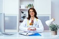 beautiful smiling female doctor showing human heart mockup in office Royalty Free Stock Photo