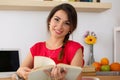 Beautiful smiling female student sitting in her room half turn s Royalty Free Stock Photo