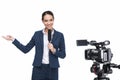 beautiful smiling female television reporter with microphone looking at camera,