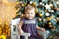 Beautiful smiling gir. Portrait of little girl near christmas tree Royalty Free Stock Photo