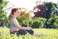 Beautiful smiling girl in activewear relax in park Royalty Free Stock Photo