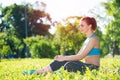 Beautiful smiling girl in activewear relax in park Royalty Free Stock Photo