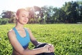 Beautiful smiling girl in activewear relax in park Royalty Free Stock Photo