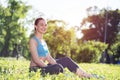 Beautiful smiling girl in activewear relax in park Royalty Free Stock Photo