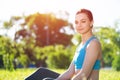 Beautiful smiling girl in activewear relax in park Royalty Free Stock Photo