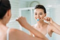 beautiful smiling girl brushing teeth at mirror Royalty Free Stock Photo