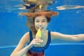 Beautiful smiling girl eating yellow ice cream underwater Royalty Free Stock Photo