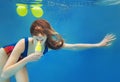 Beautiful smiling girl eating yellow ice cream underwater Royalty Free Stock Photo