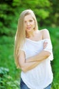 Beautiful smiling girl looking at you against spring park background Royalty Free Stock Photo