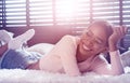 Beautiful smiling girl relaxing on her bed at home Royalty Free Stock Photo