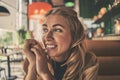 Beautiful smiling girl sit at cafe and look somewhere or waiting for someone Royalty Free Stock Photo