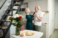 Beautiful, smiling, happy senior couple, man and woman celebrating marriage anniversary, dancing at home. Flowers and Royalty Free Stock Photo