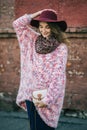 Beautiful smiling happy woman in hat. Retro fashion. Summer hat with large brim over wall background Royalty Free Stock Photo