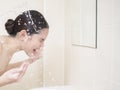 A beautiful woman is washing her face Royalty Free Stock Photo