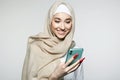 beautiful smiling islamic young woman with smartphone. beauty Happy girl in hijab