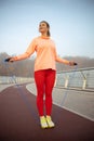 Beautiful smiling lady standing on skipping rope Royalty Free Stock Photo