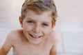 Beautiful Smiling Little Boy Portrait on warm sunny summer day. Happy kid looking at the camera. Adorable child with Royalty Free Stock Photo