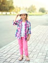 Beautiful smiling little girl child wearing pink checkered shirt and hat Royalty Free Stock Photo