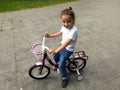 Beautiful smiling little girl riding bicycle
