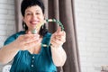 Beautiful smiling middle aged woman admiring the jewel necklace