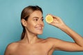 Beautiful smiling model with natural makeup, glowing facial skin and citrus fruit Royalty Free Stock Photo