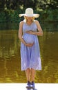 Beautiful smiling pregnant woman relaxing outside in the garden Royalty Free Stock Photo