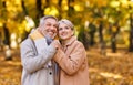 Beautiful smiling senior family couple husband and wife hugging   with love  in park on autumn day Royalty Free Stock Photo