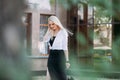 beautiful smiling slender woman with long blond hair, in a black long dress and a white shirt Royalty Free Stock Photo