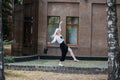 A beautiful smiling slender woman with long blond hair walks along the city street Royalty Free Stock Photo