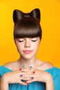 Beautiful smiling teen girl with bow hairstyle, makeup and colourful manicured polish nails. Funny girl in blue dress showing man Royalty Free Stock Photo