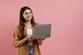 Beautiful smiling teen girl holding laptop and looking aside at copy space Royalty Free Stock Photo