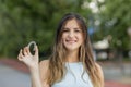 Beautiful smiling Turkish woman is holding an invisalign bracer