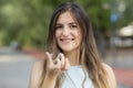 Beautiful smiling Turkish woman is holding an invisalign bracer