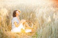 Smiling woman in bright clothing among spikes in the early morning sunlight Royalty Free Stock Photo