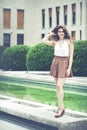 Beautiful smiling woman with curly hair. Urban elegant look Royalty Free Stock Photo