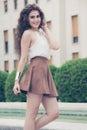 Beautiful smiling woman with curly hair. Urban look Royalty Free Stock Photo