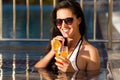 Beautiful smiling woman drinking a cocktail in a pool Royalty Free Stock Photo
