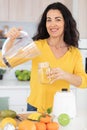 Beautiful smiling woman drinking fresh orange juice Royalty Free Stock Photo