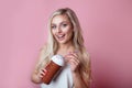 Beautiful smiling blond woman drinking ice cream cocktail over pink background Royalty Free Stock Photo