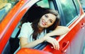 Beautiful smiling woman driver behind wheel red car Royalty Free Stock Photo