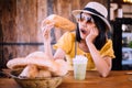 Beautiful smiling woman eathing bread and sitting in coffee shop,Happy and smile,Relaxing time Royalty Free Stock Photo